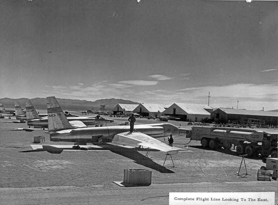 Various aircrafts lined up in a flight line.